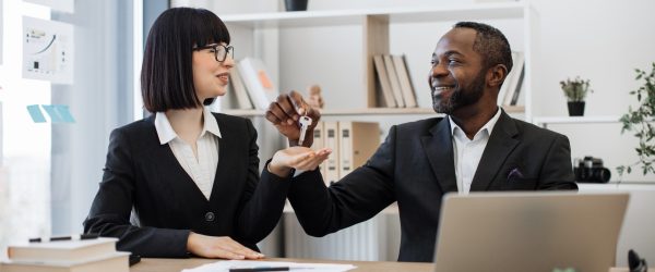 businessman-giving-house-keys-to-female-coworker-i-2024-12-13-02-44-17-utc-ZSC_IcOw0-transformed